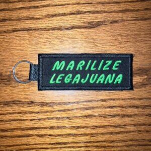 Hilarious embroidered key chain on black leather